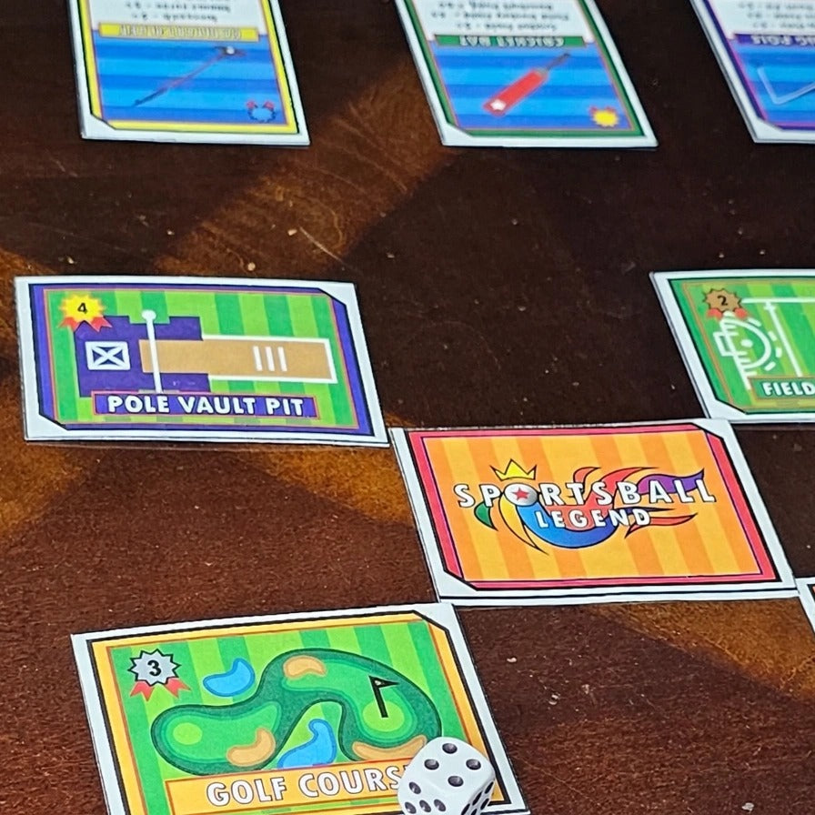 SPORTSBALL! gameplay with location cards, legend card and dice on table